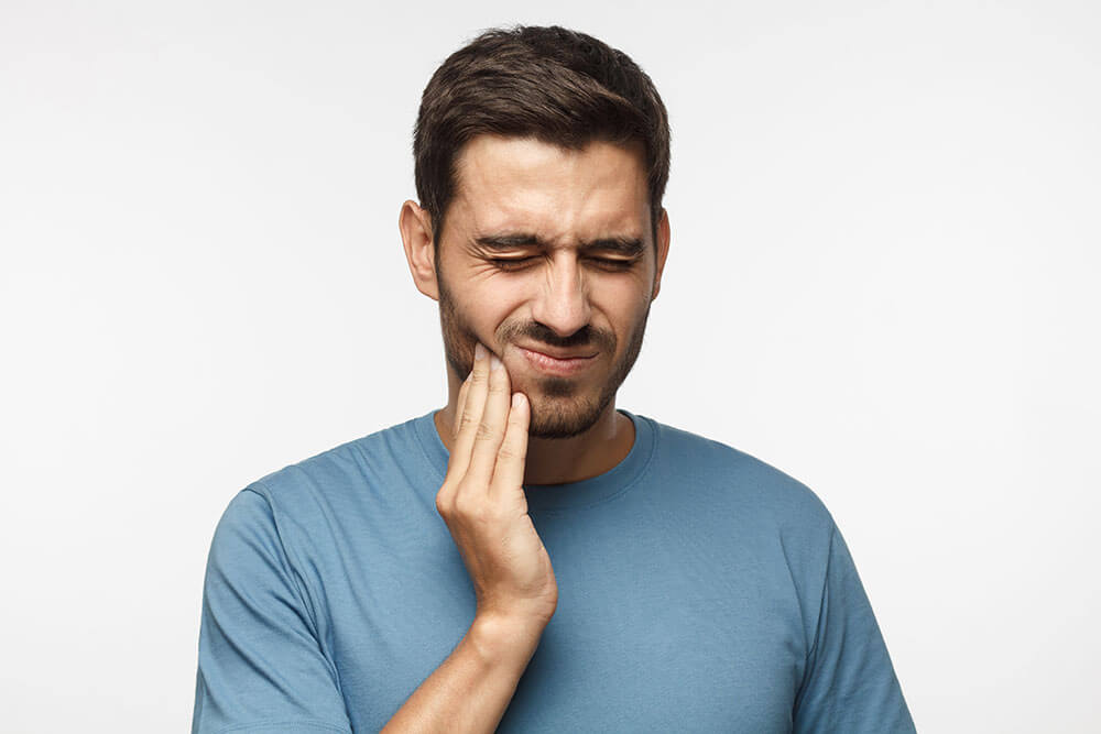 Man in pain do to TMJ disorder