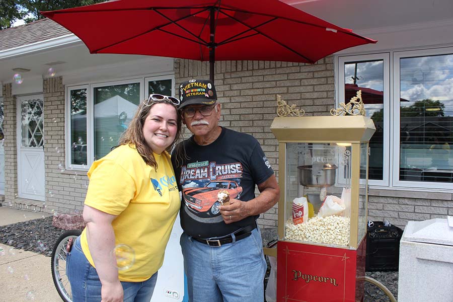 happy dentist smiling with man next to popcorn machine