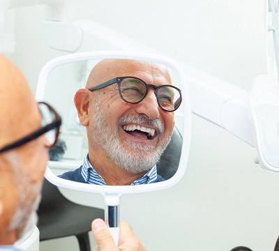 man smiling at the dentist